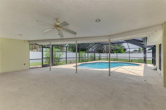 5124 Palm Aire Dr, Sarasota, FL 34243 - view of swimming pool featuring a ceiling fan, a fenced backyard, a patio, and glass enclosure