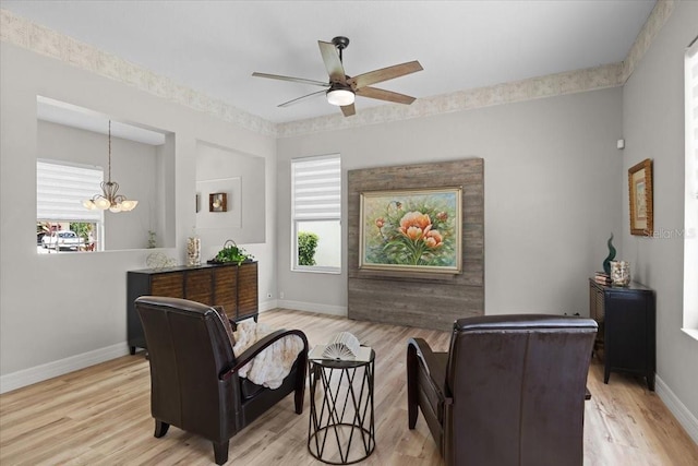 11839 Shrewsbury Ln, Parrish, FL 34219 - living room with wood finished floors, ceiling fan, and a chandelier