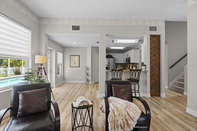 11839 Shrewsbury Ln, Parrish, FL 34219 - living area featuring light wood finished floors and stairs