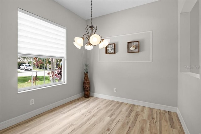 11839 Shrewsbury Ln, Parrish, FL 34219 - empty room featuring a chandelier and wood finished floors