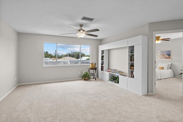 11839 Shrewsbury Ln, Parrish, FL 34219 - living room with carpet, a ceiling fan, and a textured ceiling