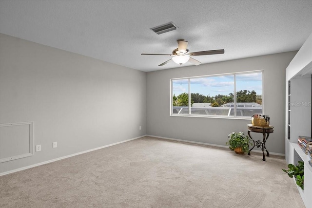 11839 Shrewsbury Ln, Parrish, FL 34219 - empty room with a ceiling fan, light colored carpet, and a textured ceiling