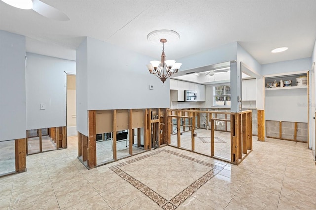 2115 9th Ave W Unit 3D, Bradenton, FL 34205 - unfurnished dining area featuring a ceiling fan and a chandelier
