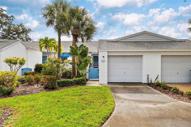 805 Waterside Ln, Bradenton, FL 34209 - view of front of home with concrete driveway, roof with shingles, a garage, stucco siding, and a front lawn