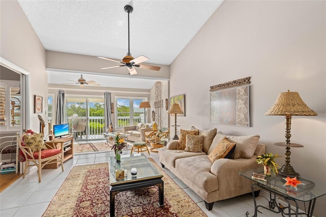 805 Waterside Ln, Bradenton, FL 34209 - living room featuring a ceiling fan, a textured ceiling, light tile patterned floors, and vaulted ceiling