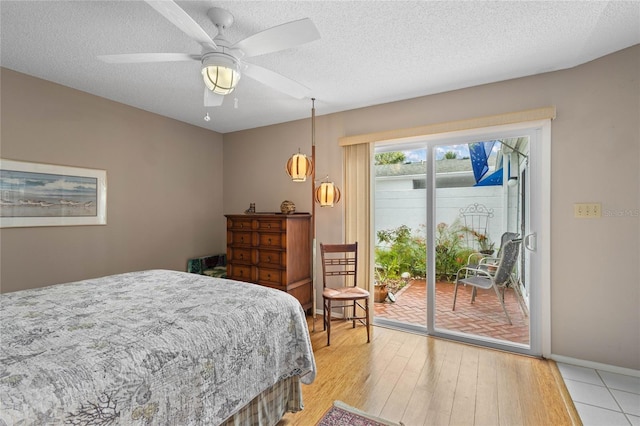 805 Waterside Ln, Bradenton, FL 34209 - bedroom with access to exterior, light wood-type flooring, a textured ceiling, and a ceiling fan