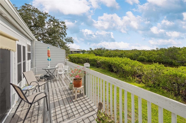 805 Waterside Ln, Bradenton, FL 34209 - wooden deck featuring a yard and outdoor dining area