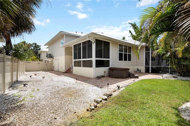 1801 Highland Rd, Osprey, FL 34229 - rear view of property with a hot tub, a sunroom, a fenced backyard, a patio area, and a gate