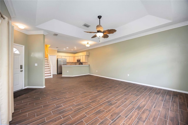 1801 Highland Rd, Osprey, FL 34229 - unfurnished living room with a ceiling fan, ornamental molding, dark wood-style flooring, stairway, and a tray ceiling