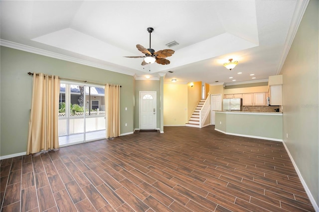 1801 Highland Rd, Osprey, FL 34229 - unfurnished living room with a tray ceiling, ceiling fan, crown molding, dark wood-style floors, and stairway