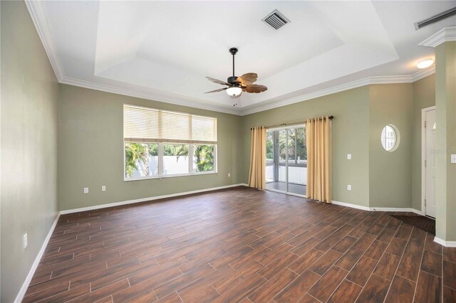 1801 Highland Rd, Osprey, FL 34229 - spare room with a tray ceiling, a ceiling fan, dark wood-style flooring, and ornamental molding