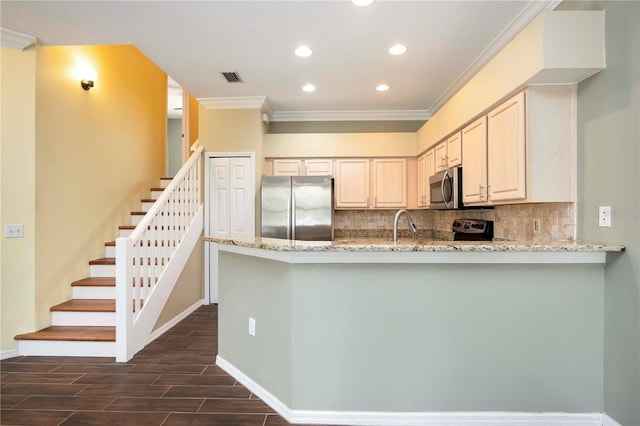 1801 Highland Rd, Osprey, FL 34229 - kitchen with stainless steel appliances, ornamental molding, recessed lighting, decorative backsplash, and light stone counters