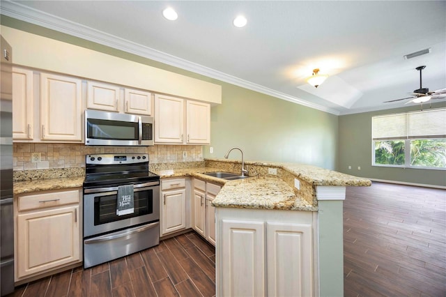 1801 Highland Rd, Osprey, FL 34229 - kitchen featuring appliances with stainless steel finishes, a peninsula, crown molding, dark wood-style flooring, and tasteful backsplash