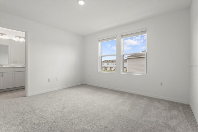 8705 Winter Breeze Way, Sarasota, FL 34241 - unfurnished bedroom featuring light colored carpet and ensuite bathroom