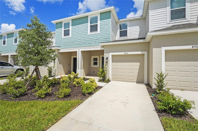 8705 Winter Breeze Way, Sarasota, FL 34241 - townhome / multi-family property featuring stucco siding, driveway, and an attached garage