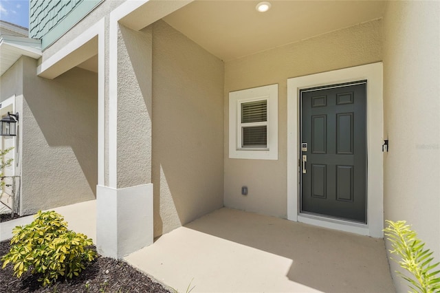 8705 Winter Breeze Way, Sarasota, FL 34241 - view of exterior entry featuring stucco siding