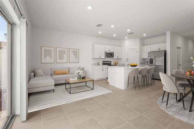 8705 Winter Breeze Way, Sarasota, FL 34241 - living room featuring light tile patterned floors and recessed lighting