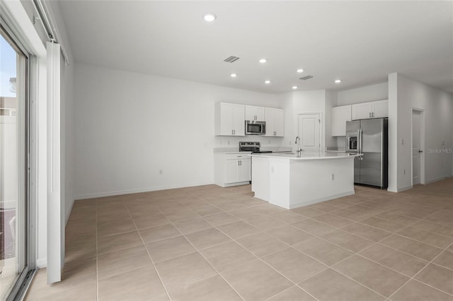 8705 Winter Breeze Way, Sarasota, FL 34241 - kitchen with appliances with stainless steel finishes, recessed lighting, light countertops, a kitchen island with sink, and white cabinets