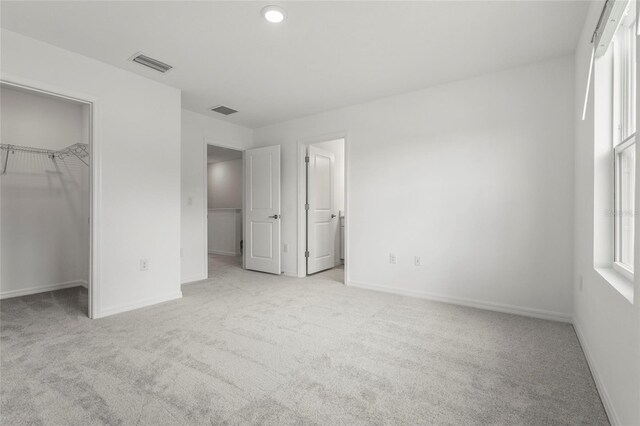 8705 Winter Breeze Way, Sarasota, FL 34241 - unfurnished bedroom with carpet flooring, a spacious closet, and a closet
