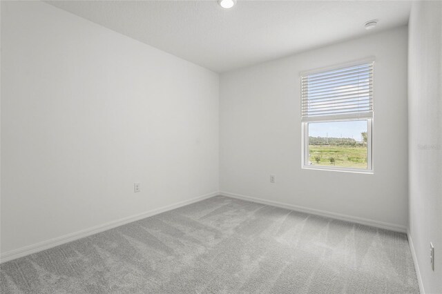 8705 Winter Breeze Way, Sarasota, FL 34241 - carpeted spare room with baseboards and a smoke detector