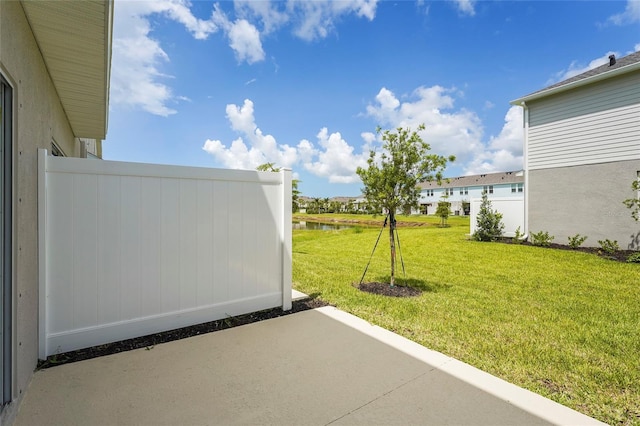 8705 Winter Breeze Way, Sarasota, FL 34241 - view of grassy yard with a water view and a patio area