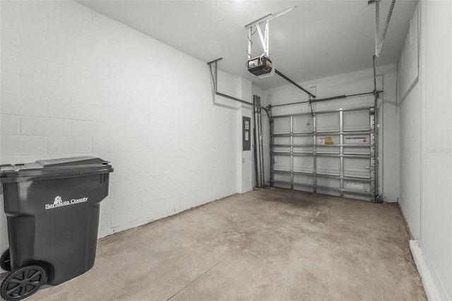 8705 Winter Breeze Way, Sarasota, FL 34241 - garage with a garage door opener, concrete block wall, and electric panel