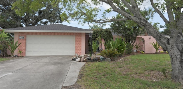 1308 63rd St NW, Bradenton, FL 34209 - view of front of property featuring brick siding, driveway, an attached garage, and a front lawn