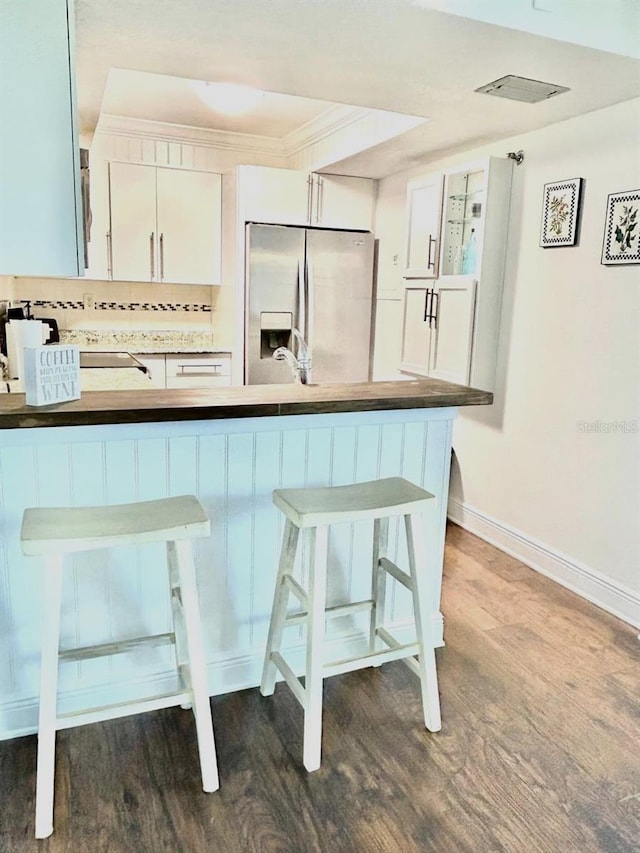 21405 Olean Blvd Unit 224, Port Charlotte, FL 33952 - kitchen featuring stainless steel refrigerator with ice dispenser, dark wood-style flooring, a kitchen breakfast bar, white cabinetry, and ornamental molding