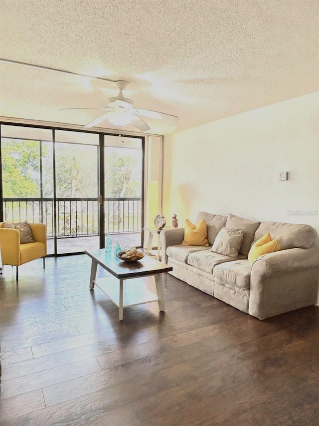 21405 Olean Blvd Unit 224, Port Charlotte, FL 33952 - living area featuring a textured ceiling, ceiling fan, wood finished floors, and expansive windows