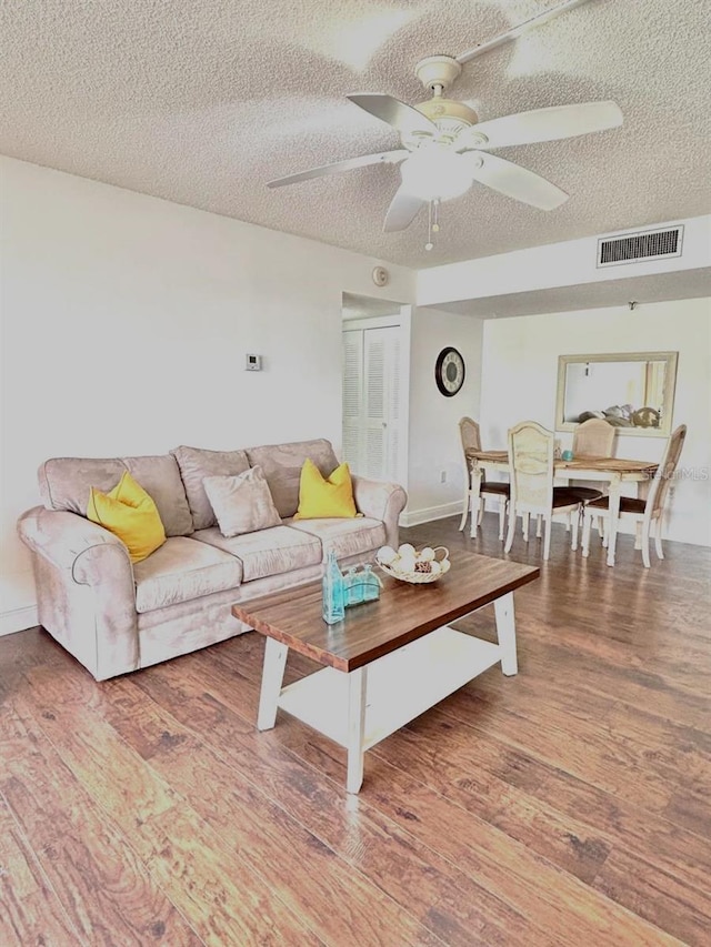 21405 Olean Blvd Unit 224, Port Charlotte, FL 33952 - living room featuring a textured ceiling, ceiling fan, and wood finished floors