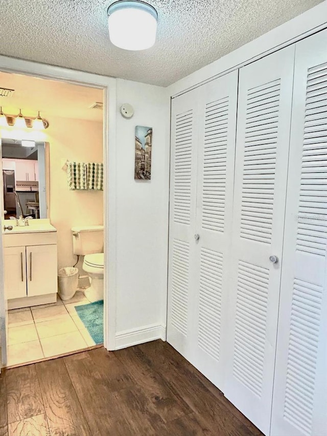 21405 Olean Blvd Unit 224, Port Charlotte, FL 33952 - corridor featuring dark wood-type flooring and a textured ceiling