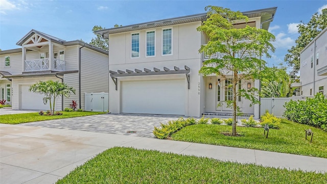 2590 Floyd St, Sarasota, FL 34239 - view of front of home with driveway, an attached garage, stucco siding, and a balcony