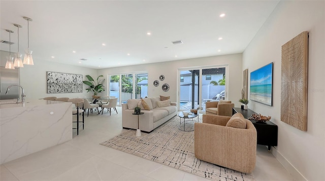 2590 Floyd St, Sarasota, FL 34239 - living area with recessed lighting and light tile patterned flooring