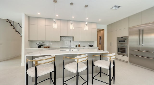 2590 Floyd St, Sarasota, FL 34239 - kitchen with stainless steel appliances, modern cabinets, light countertops, and a kitchen bar