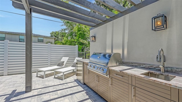 2590 Floyd St, Sarasota, FL 34239 - view of patio with exterior kitchen and a pergola