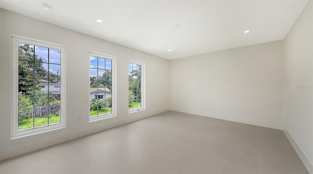 2590 Floyd St, Sarasota, FL 34239 - spare room featuring healthy amount of natural light, a smoke detector, recessed lighting, and light tile patterned floors
