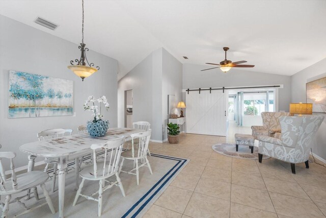 5206 19th Ave W, Bradenton, FL 34209 - dining space with lofted ceiling, a barn door, light tile patterned floors, and a ceiling fan