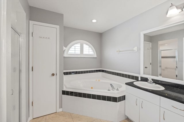 5206 19th Ave W, Bradenton, FL 34209 - bathroom featuring vanity, a jetted tub, a stall shower, and tile patterned floors