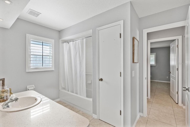 5206 19th Ave W, Bradenton, FL 34209 - full bathroom with tile patterned flooring, shower / bathtub combination with curtain, plenty of natural light, and vanity