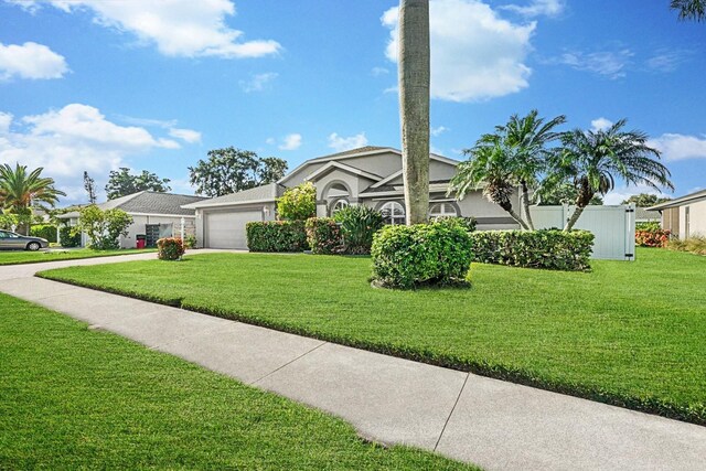 5206 19th Ave W, Bradenton, FL 34209 - view of front of home with a garage, concrete driveway, and stucco siding