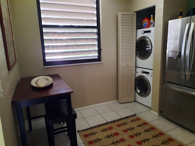 137 Pineneedle Dr Unit 137, Bradenton, FL 34210 - laundry room with stacked washing machine and dryer and light tile patterned floors