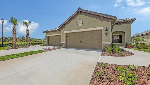 248 Altamura Cir, Nokomis, FL 34275 - mediterranean / spanish house with concrete driveway, a garage, stone siding, and stucco siding