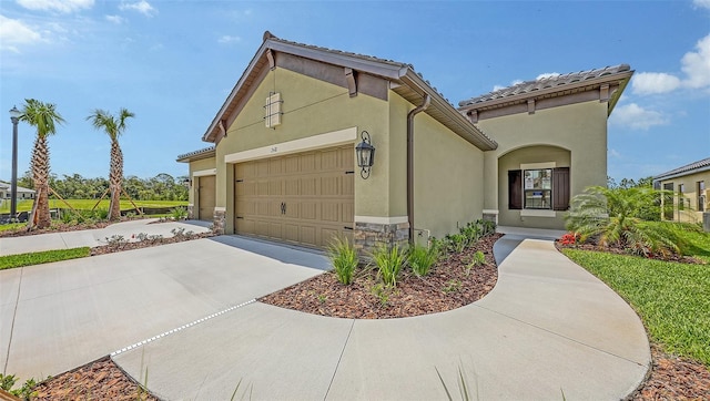 248 Altamura Cir, Nokomis, FL 34275 - mediterranean / spanish-style home with an attached garage, driveway, and stucco siding
