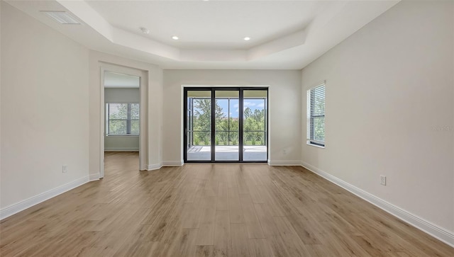 248 Altamura Cir, Nokomis, FL 34275 - unfurnished room featuring a raised ceiling, light wood-type flooring, and recessed lighting