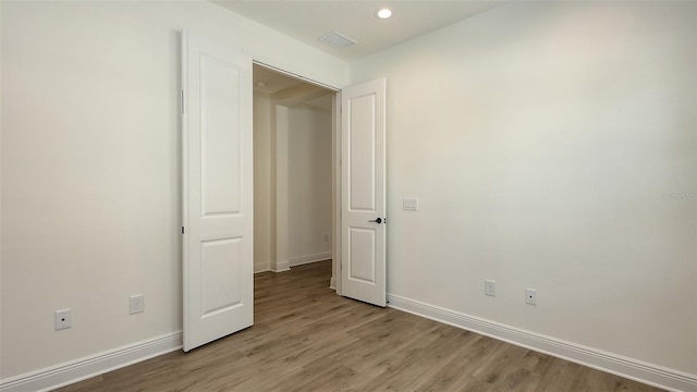 248 Altamura Cir, Nokomis, FL 34275 - empty room featuring light wood finished floors and recessed lighting