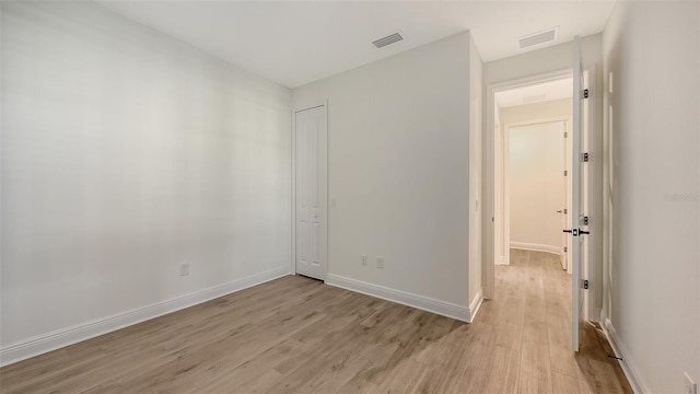 248 Altamura Cir, Nokomis, FL 34275 - unfurnished bedroom featuring light wood finished floors and a closet