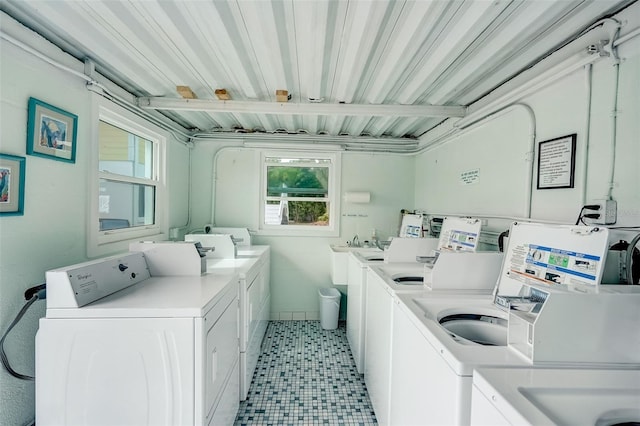 999 Inlet Cir Unit 103, Venice, FL 34285 - shared laundry room featuring washer and clothes dryer and light tile patterned floors
