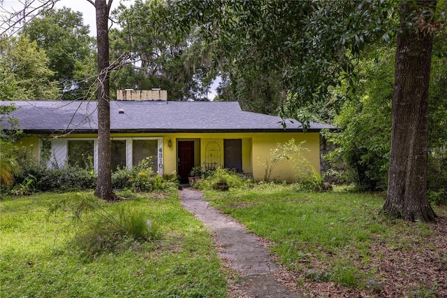 4310 NW 65th Ter, Gainesville, FL 32606 - ranch-style home with a front lawn, roof with shingles, and stucco siding