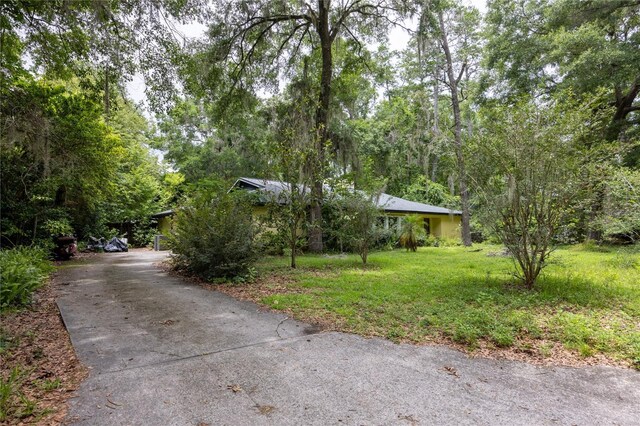 4310 NW 65th Ter, Gainesville, FL 32606 - obstructed view of property featuring a front lawn and driveway