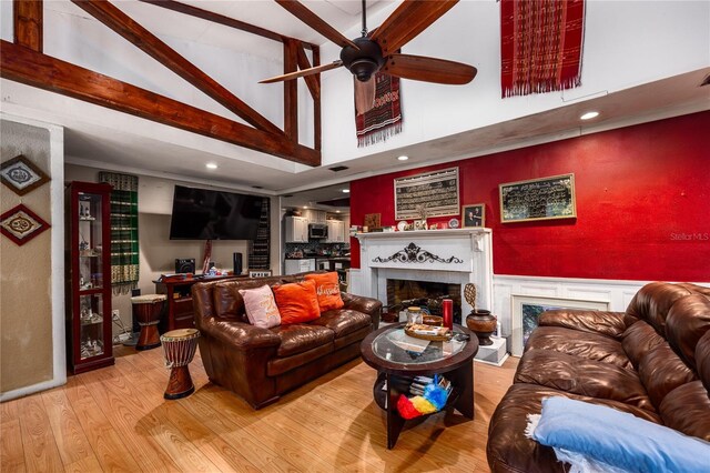 4310 NW 65th Ter, Gainesville, FL 32606 - living room with a premium fireplace, high vaulted ceiling, wood finished floors, ceiling fan, and beam ceiling